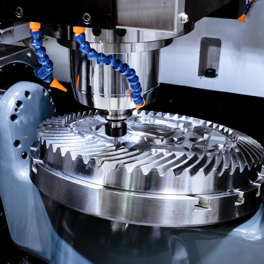 A modern CNC milling machine makes a large cogwheel. Accurate metal working. Shooting in real conditions, maybe some blurring and grain.